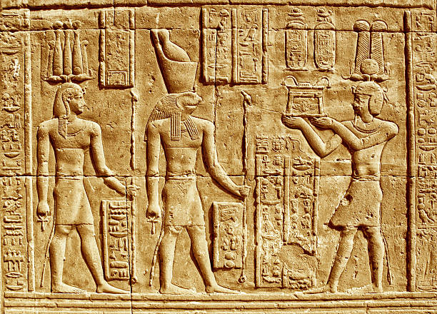 Ancient Hieroglyphics - Egyptian man making an offering to the god Horus. istockphoto 482785249 612x612 1